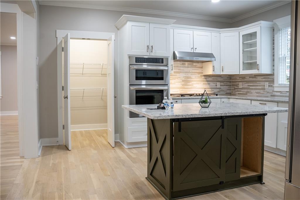 151 Cherokee Point Drive Canton, GA 30114 - Photo 90 of 163 a kitchen with kitchen island a sink appliances and cabinets
