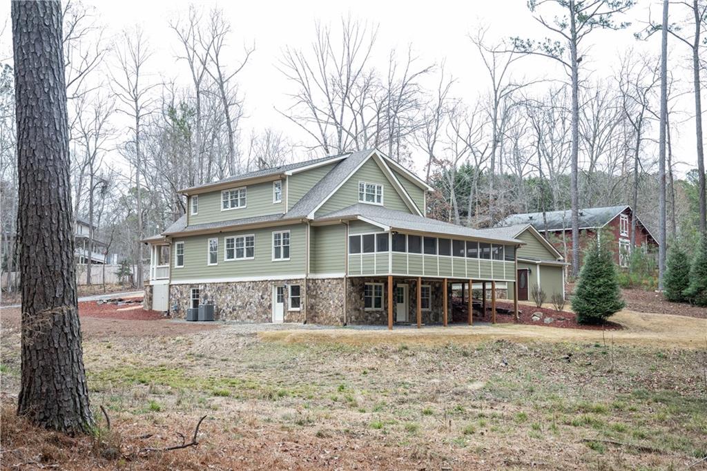 151 Cherokee Point Drive Canton, GA 30114 - Photo 9 of 163 a front view of a house with a yard covered with snow and trees
