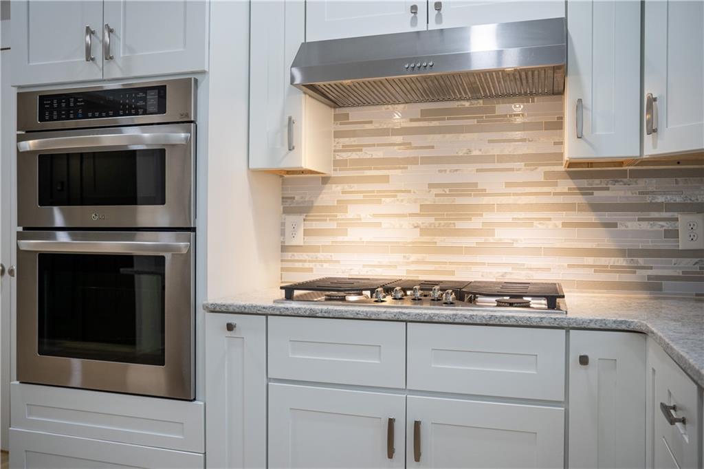 151 Cherokee Point Drive Canton, GA 30114 - Photo 94 of 163 a kitchen with granite countertop white cabinets and stainless steel appliances