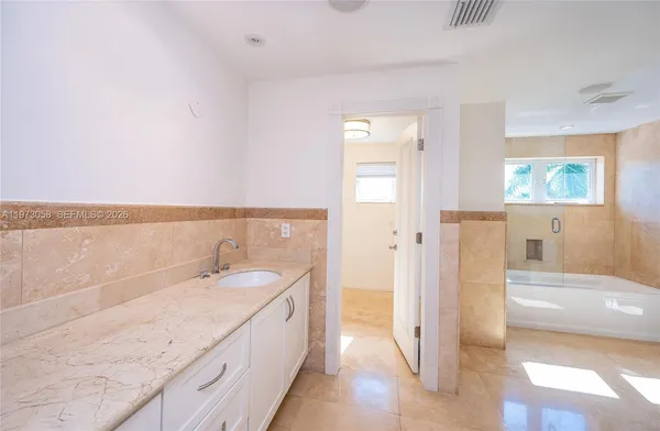 a view of a backyard with garden and patio