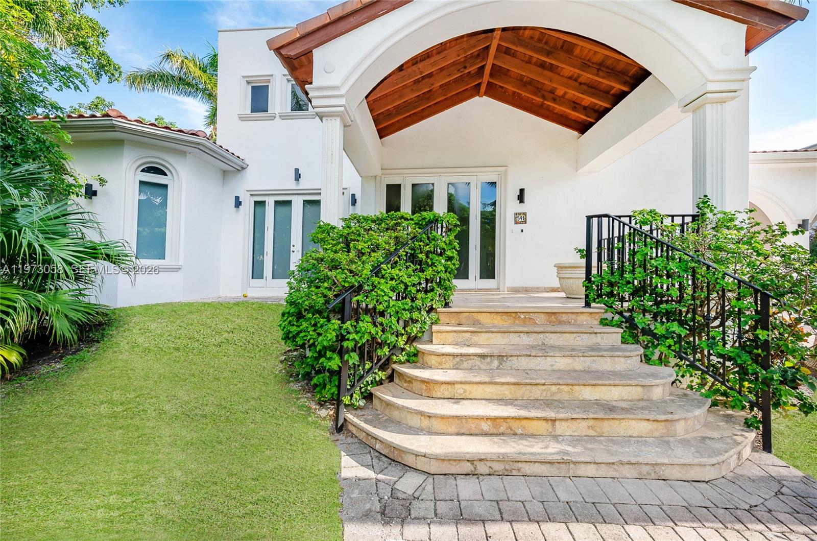 541 South Mashta Drive Key Biscayne, FL 33149 - Photo 26 of 28 a front view of a house with a garden