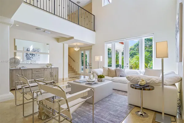 a living room with furniture and large windows