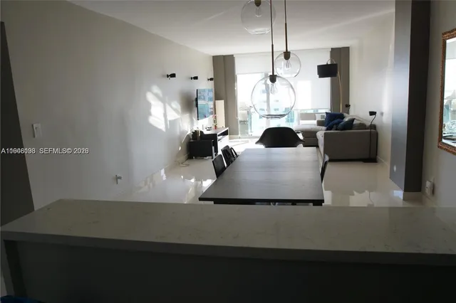 a living room with furniture and a floor to ceiling window