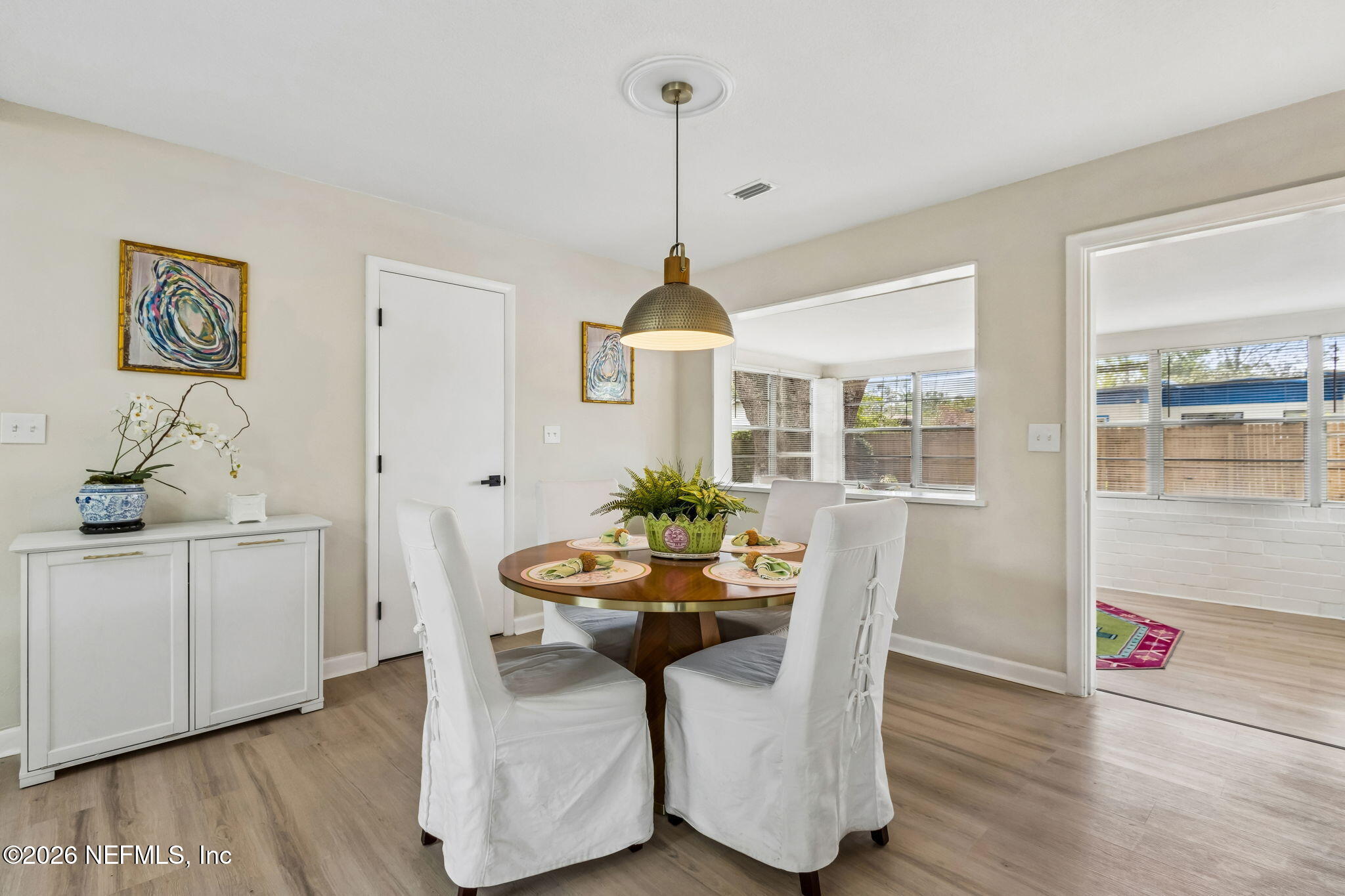 3668 Marianna Road Jacksonville, FL 32217 - Photo 12 of 28 a dining room with furniture potted plants and wooden floor