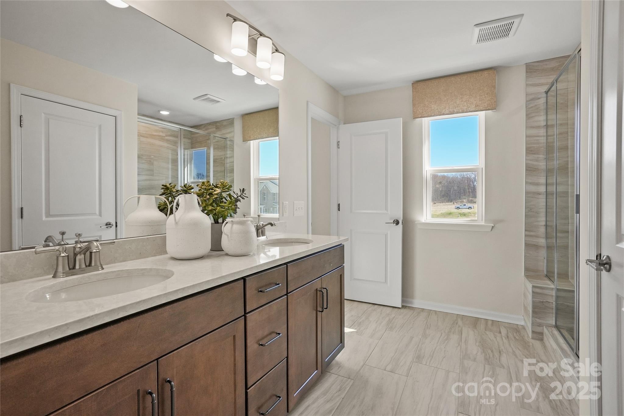 3608 Edisto Place Monroe, NC 28110 - Photo 3 of 4 a bathroom with a sink double vanity and shower