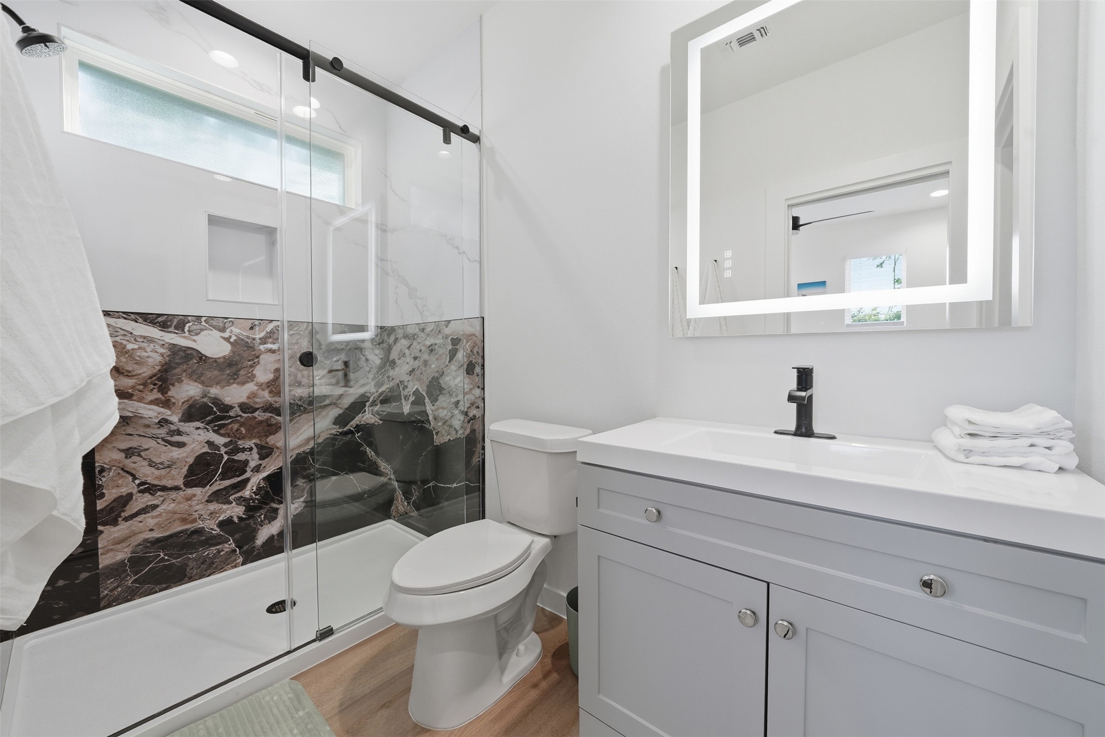 2216 Yellow Jacket Lane, Unit 2 Austin, TX 78741 - Photo 16 of 25 a bathroom with a sink a toilet and mirror