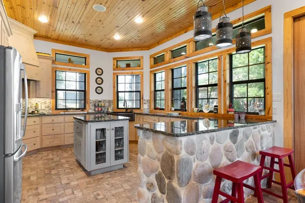 a large white kitchen with a large window