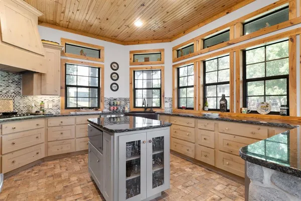 a kitchen with stainless steel appliances granite countertop a stove and more cabinets