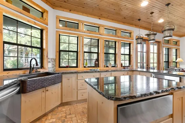 a large kitchen with stainless steel appliances lots of counter space and a window