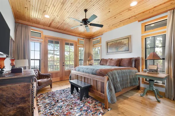 a large spacious bathroom with a tub a double vanity sink and large mirror