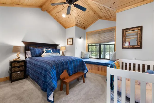 a spacious bedroom with a bed and a large window