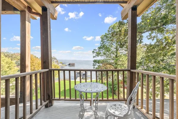 a bedroom with a bed a chandelier and dresser