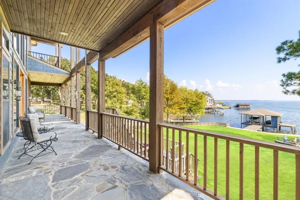 a view of a big room with a big yard and large trees