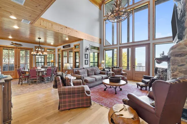 a living room with furniture and floor to ceiling windows
