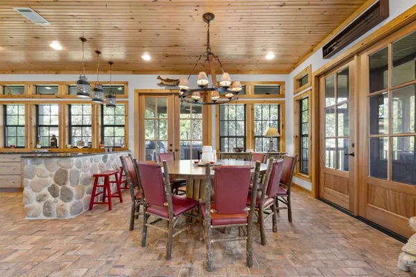 a view of a dining room with furniture wooden floor and chandelier
