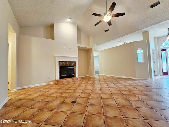 a view of an empty room with a fireplace