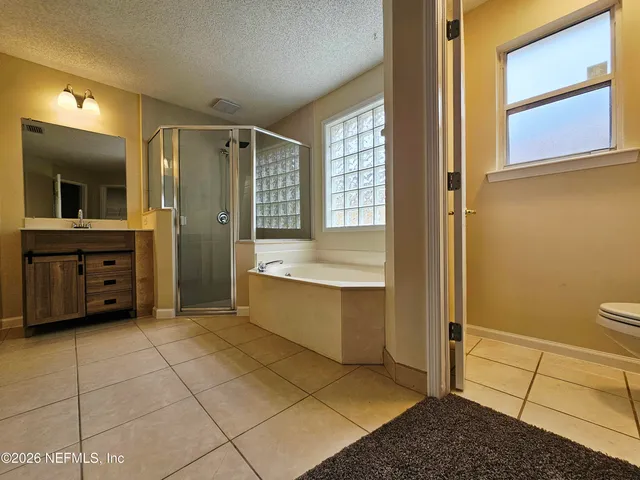 a bathroom with a tub shower and sink