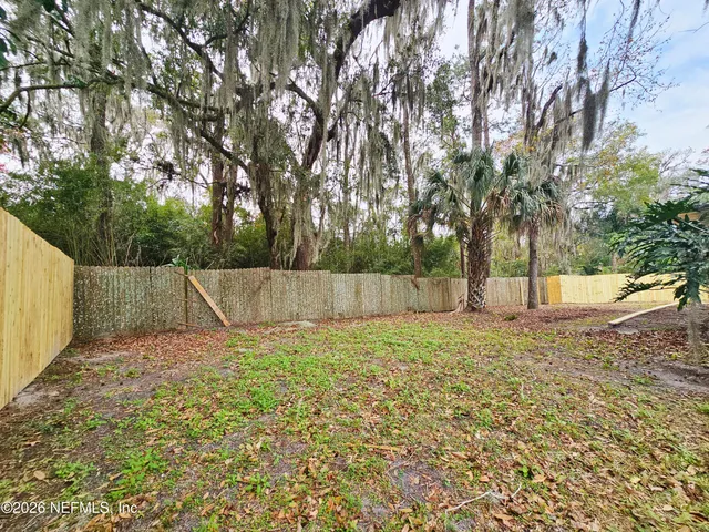 a view of a yard with a tree