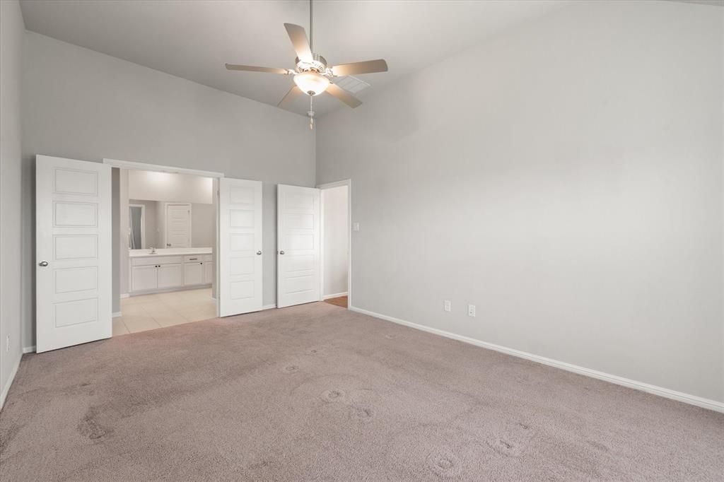 6910 Prairieside Trail Venus, TX 76084 - Photo 19 of 40 This expansive room features vaulted ceilings, a ceiling fan, and carpeted flooring
