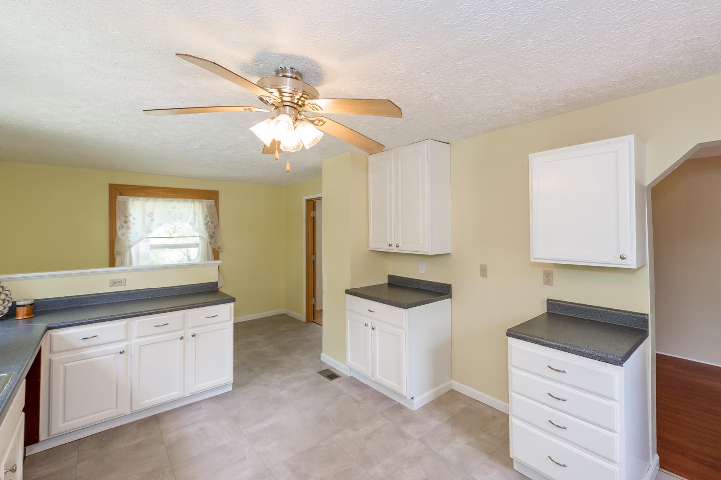 896 East Wolf Valley Road Heiskell, TN 37754 - Photo 8 of 22 a kitchen with white cabinets and appliances