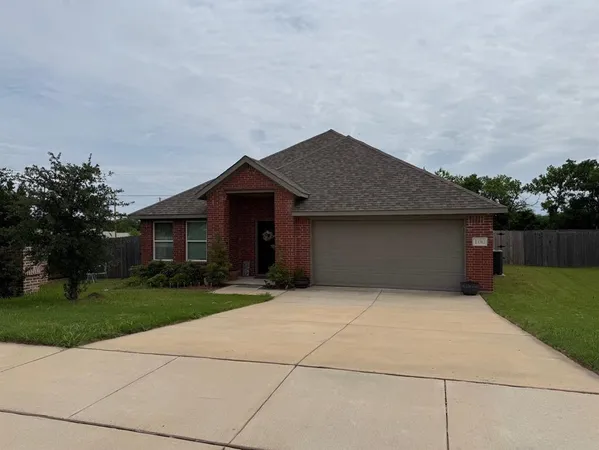 a front view of house with yard and trees