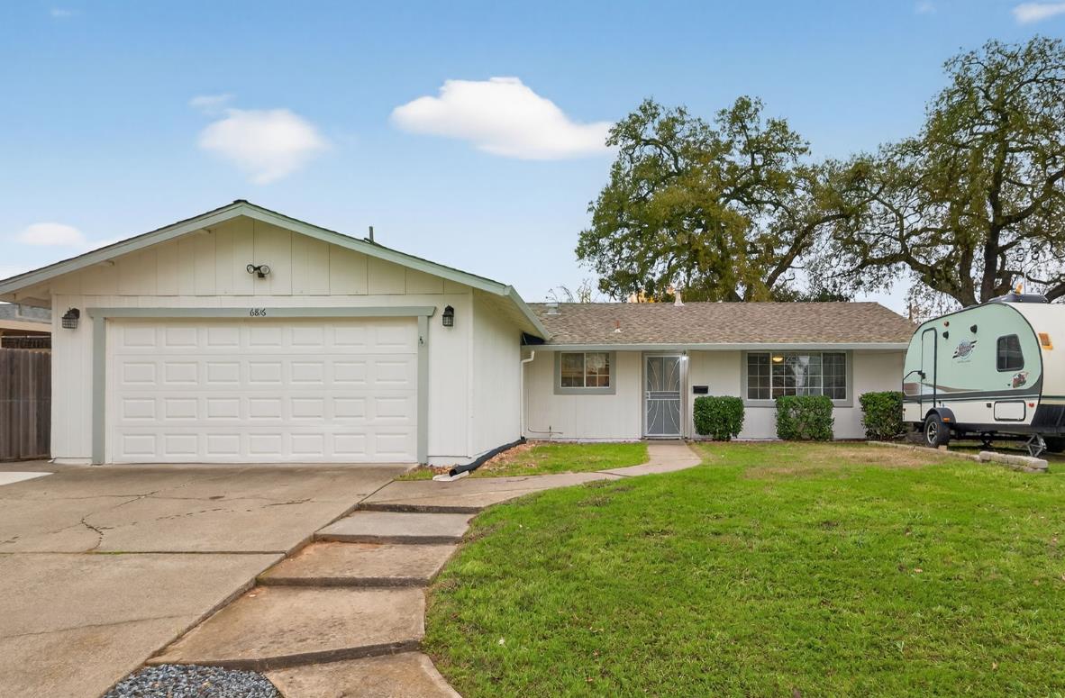 6816 Tareyton Way Citrus Heights, CA 95621 - Photo 1 of 46 a front view of a house with a garden and trees