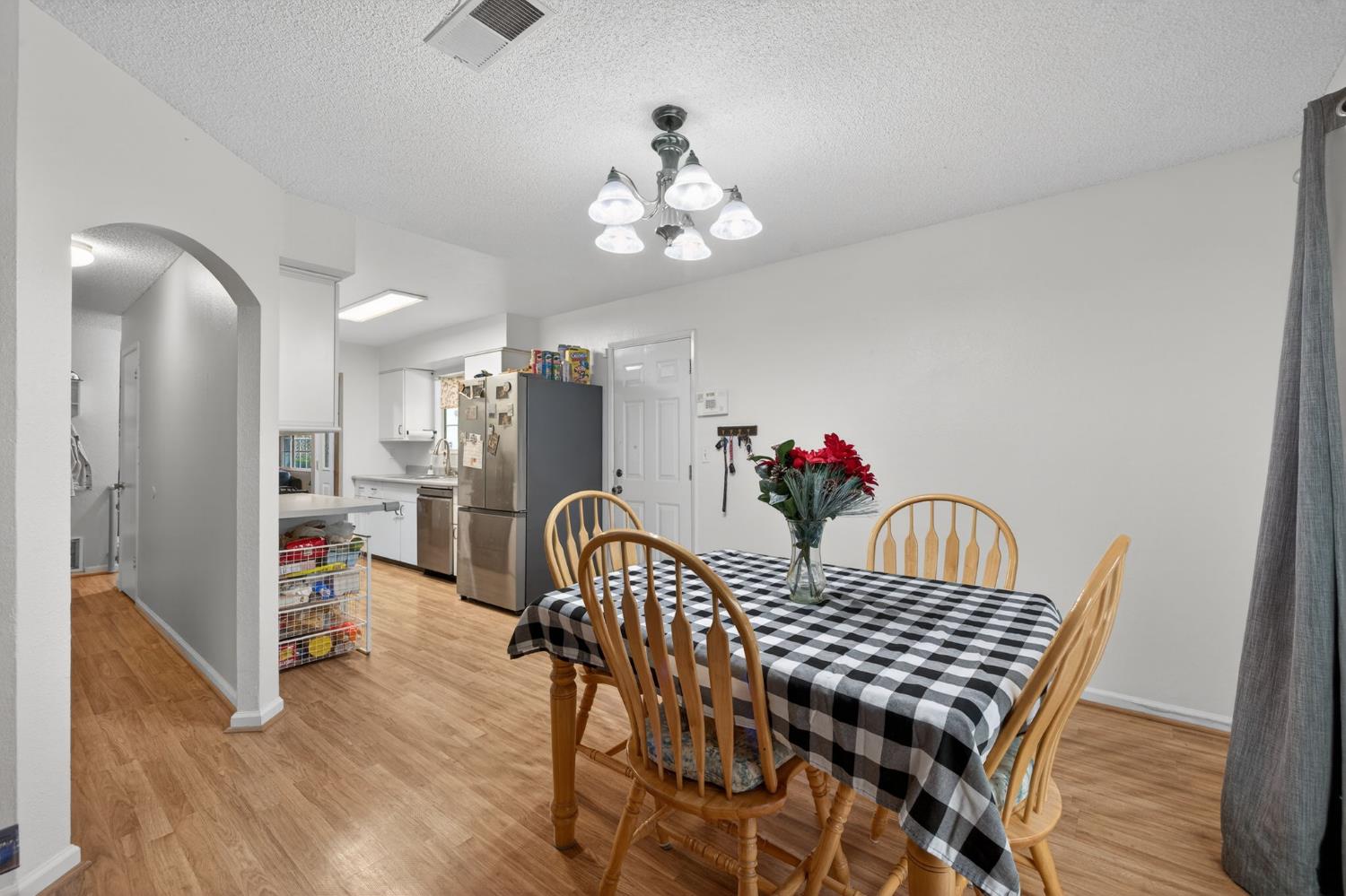 6816 Tareyton Way Citrus Heights, CA 95621 - Photo 12 of 46 a view of a dining room with furniture wooden floor and a chandelier