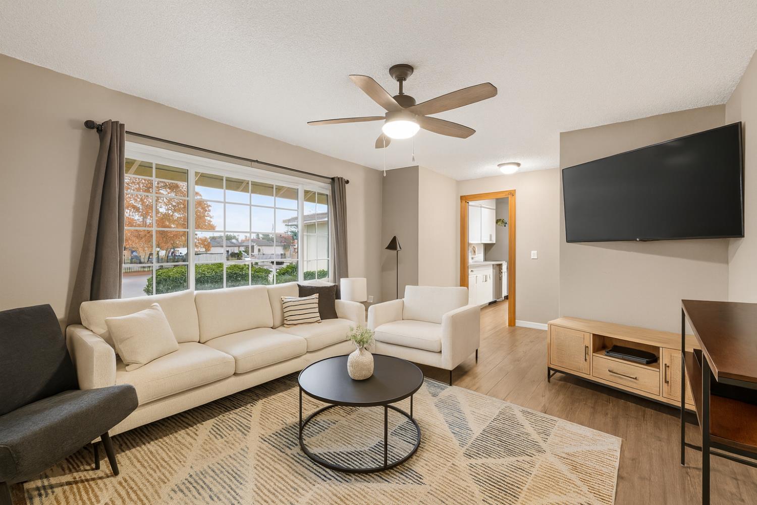 6816 Tareyton Way Citrus Heights, CA 95621 - Photo 41 of 46 a living room with furniture a flat screen tv and a large window