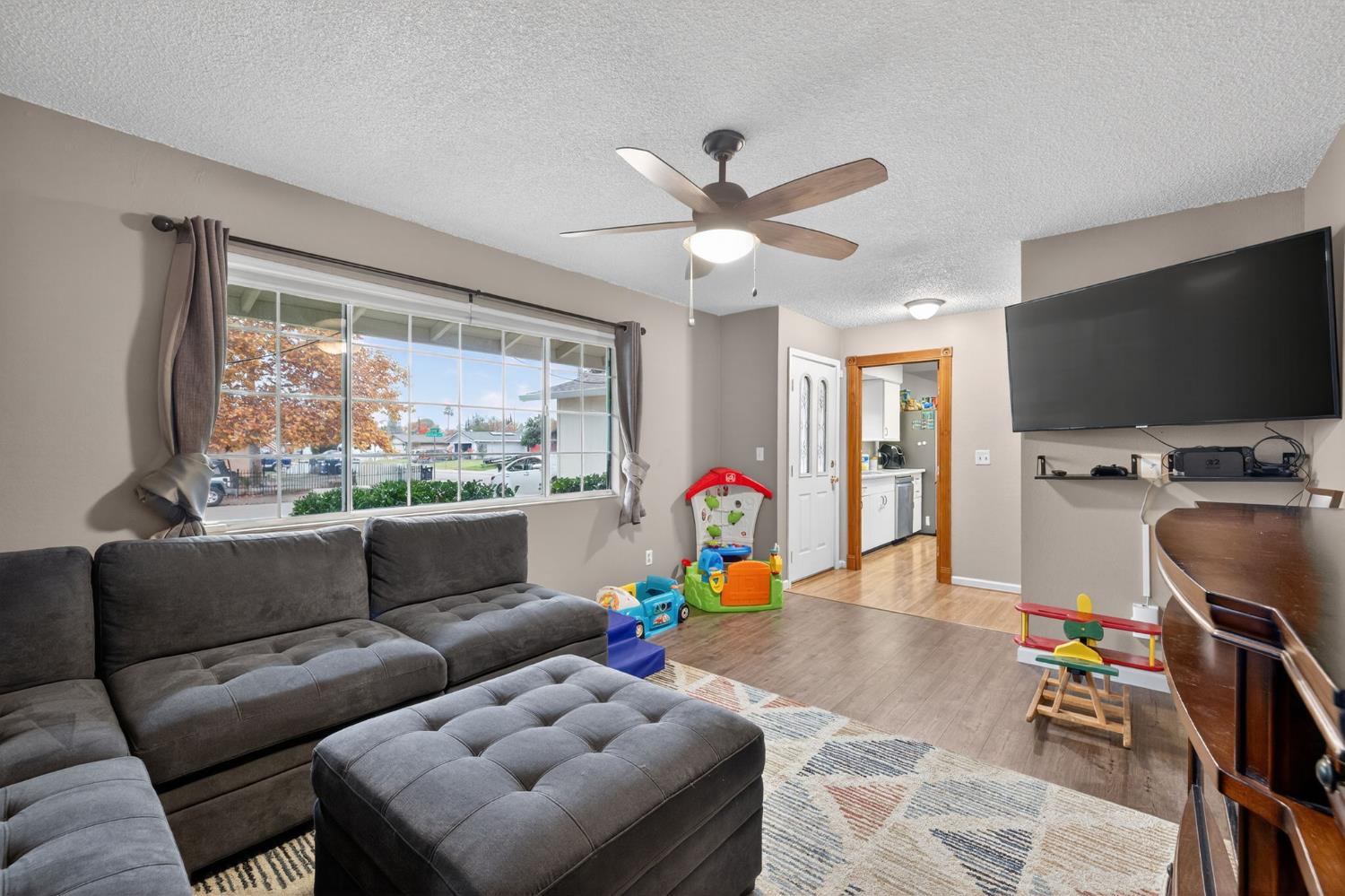 6816 Tareyton Way Citrus Heights, CA 95621 - Photo 8 of 46 a living room with furniture a flat screen tv and a large window