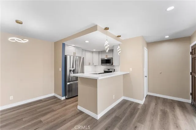 a view of kitchen with stainless steel appliances cabinets
