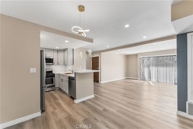 a view of kitchen with sink and refrigerator