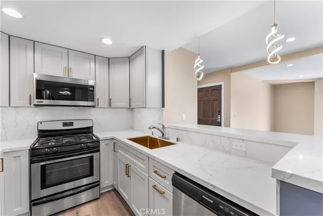 a kitchen with a sink stove and microwave
