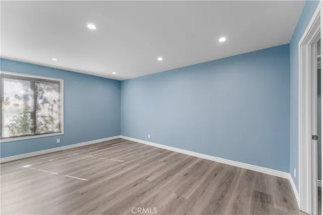 an empty room with windows and closet