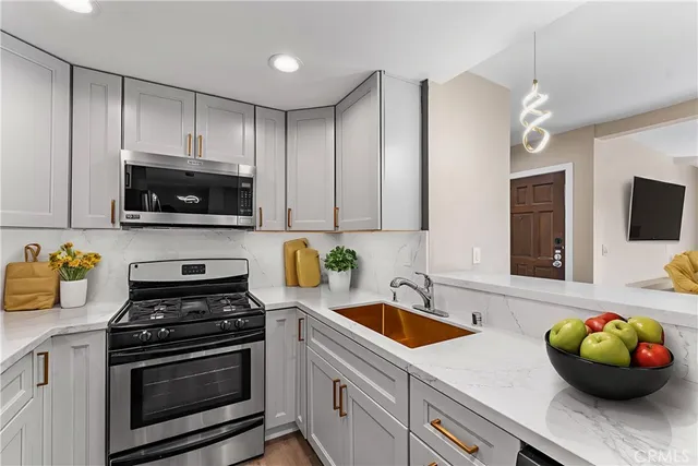 a kitchen with a sink a stove and microwave