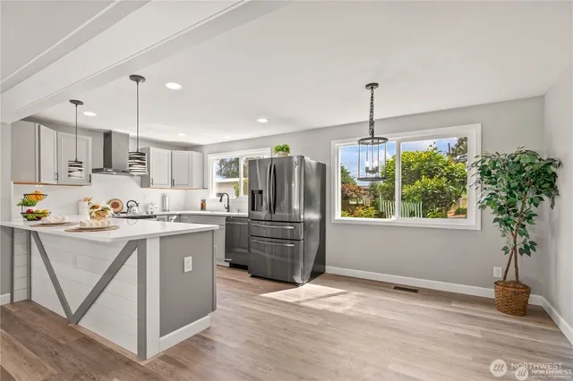 a kitchen with refrigerator and window