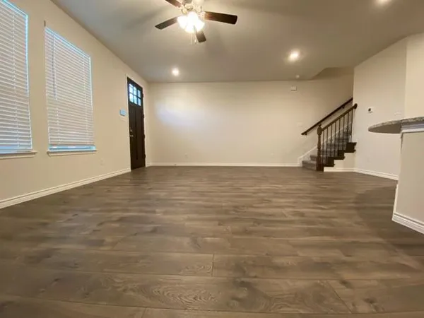 a view of an empty room with stairs and ventilation