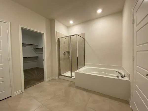 a bathroom with a bathtub and a shower