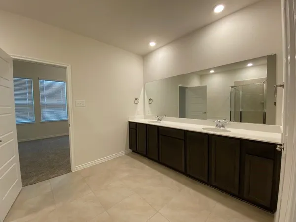 a bathroom with a double vanity sink and mirror