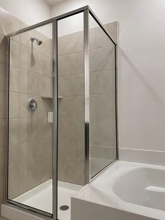 a bathroom with a bathtub and a shower