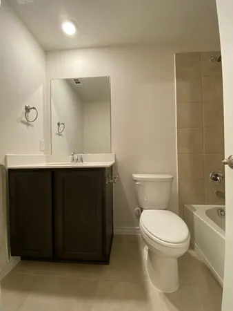 a bathroom with a toilet a sink and mirror