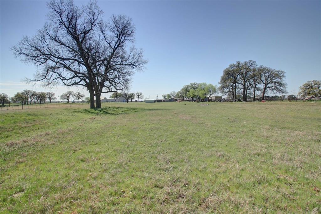 3559 Springfield Road Springtown, TX 76082 - Photo 28 of 36 a view of yard with ocean and trees in the background