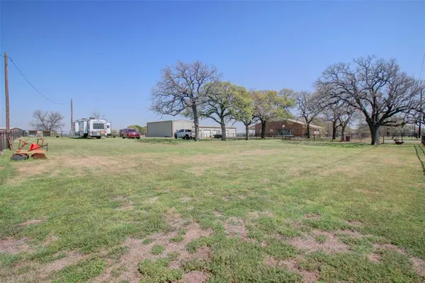 a view of a yard with a house in the background
