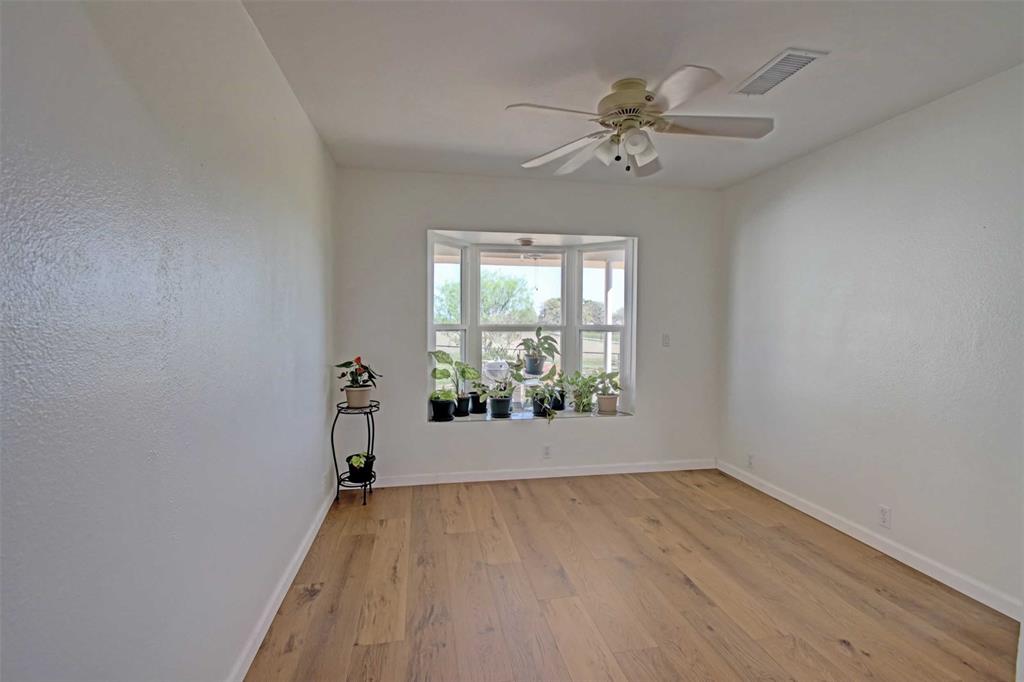 3559 Springfield Road Springtown, TX 76082 - Photo 8 of 36 wooden floor in an empty room with a window