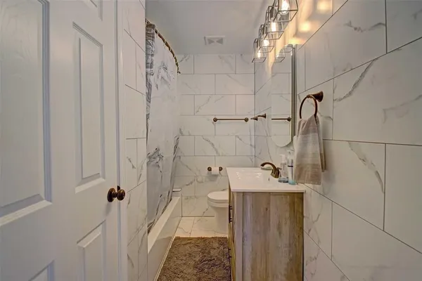 a bathroom with a sink and shower