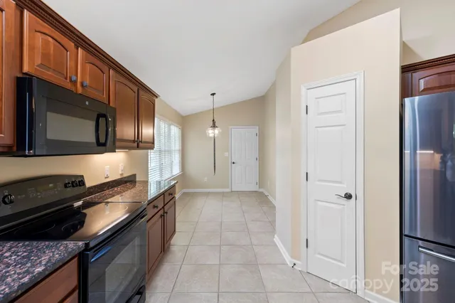 a kitchen with a refrigerator stove and cabinets