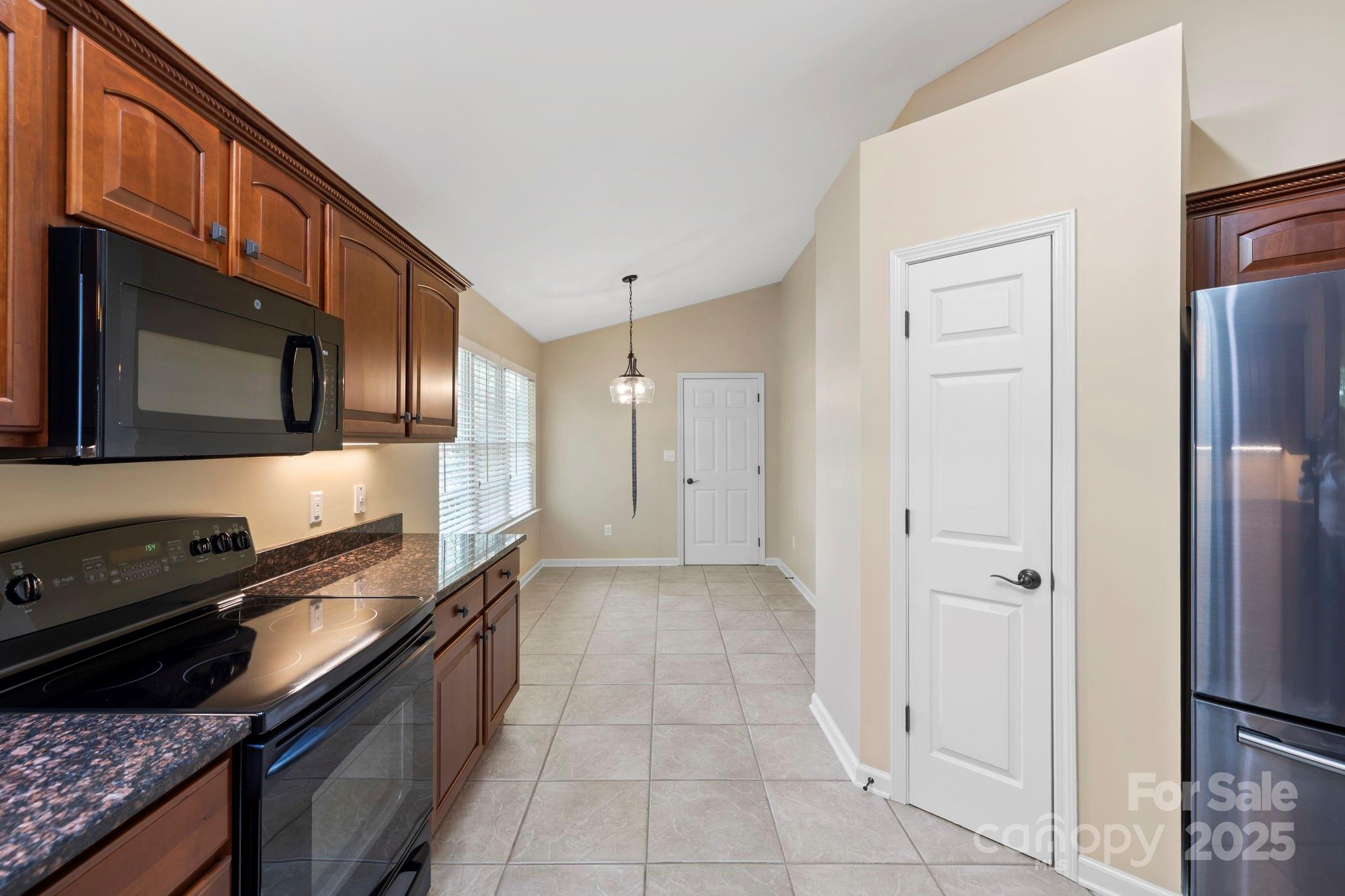241 Fairway View Drive Etowah, NC 28729 - Photo 20 of 37 a kitchen with a refrigerator stove and cabinets