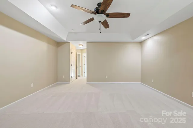 an empty room with a ceiling fan and a ceiling fan