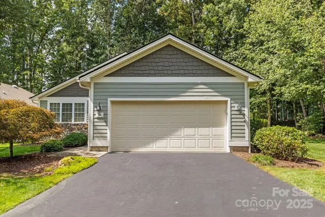 a front view of house with garage and yard