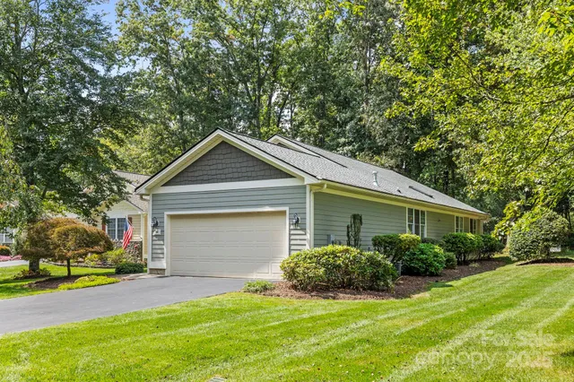 a view of a house with a yard and garage