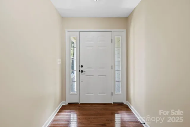 an empty room with wooden floor and closet